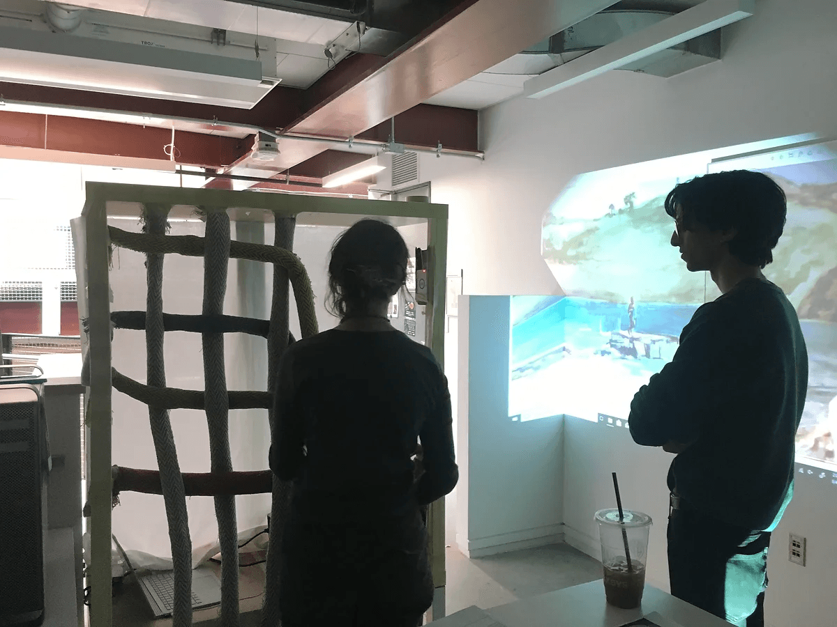 Early user test of The Loom — a physical rope-and-frame loom next to a projected painting that changes based on the rope arrangement